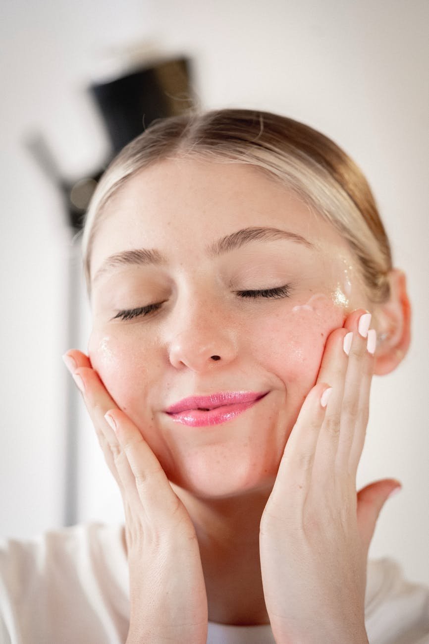 woman practicing skincare routine with cream