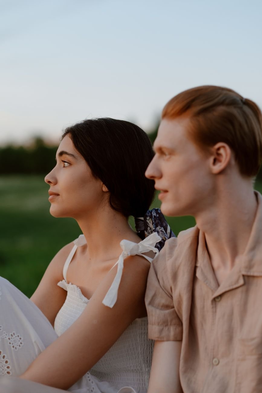 couple sitting on field