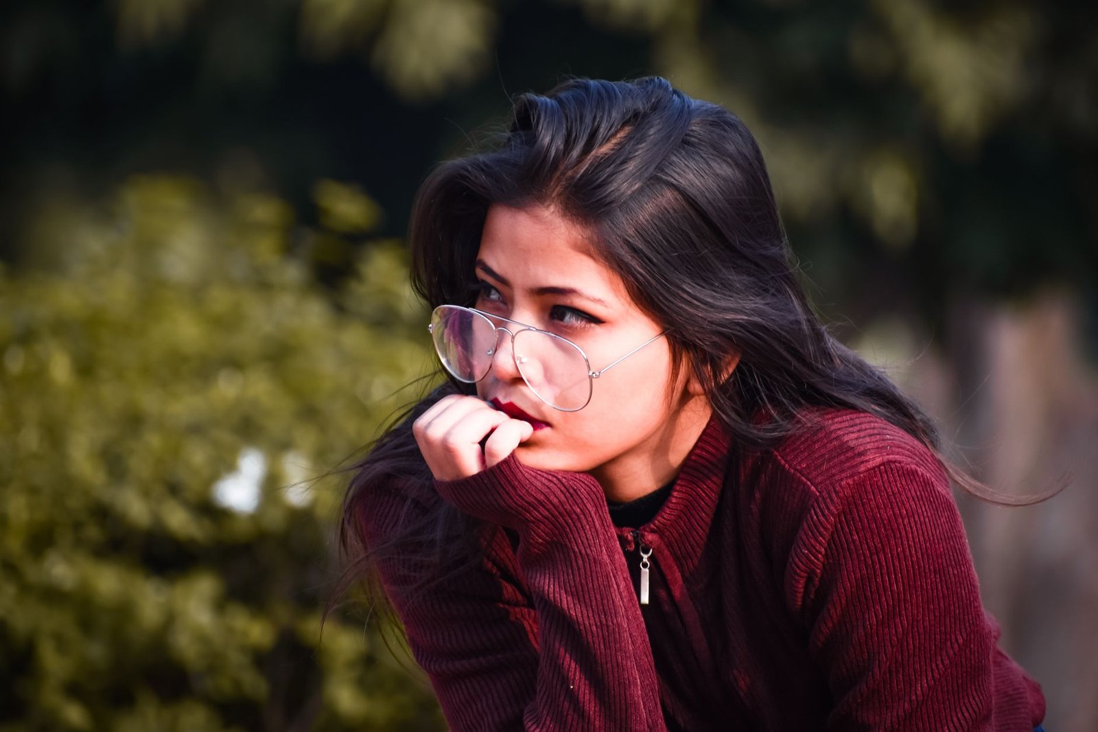 woman in red zip up jacket with eyeglasses
