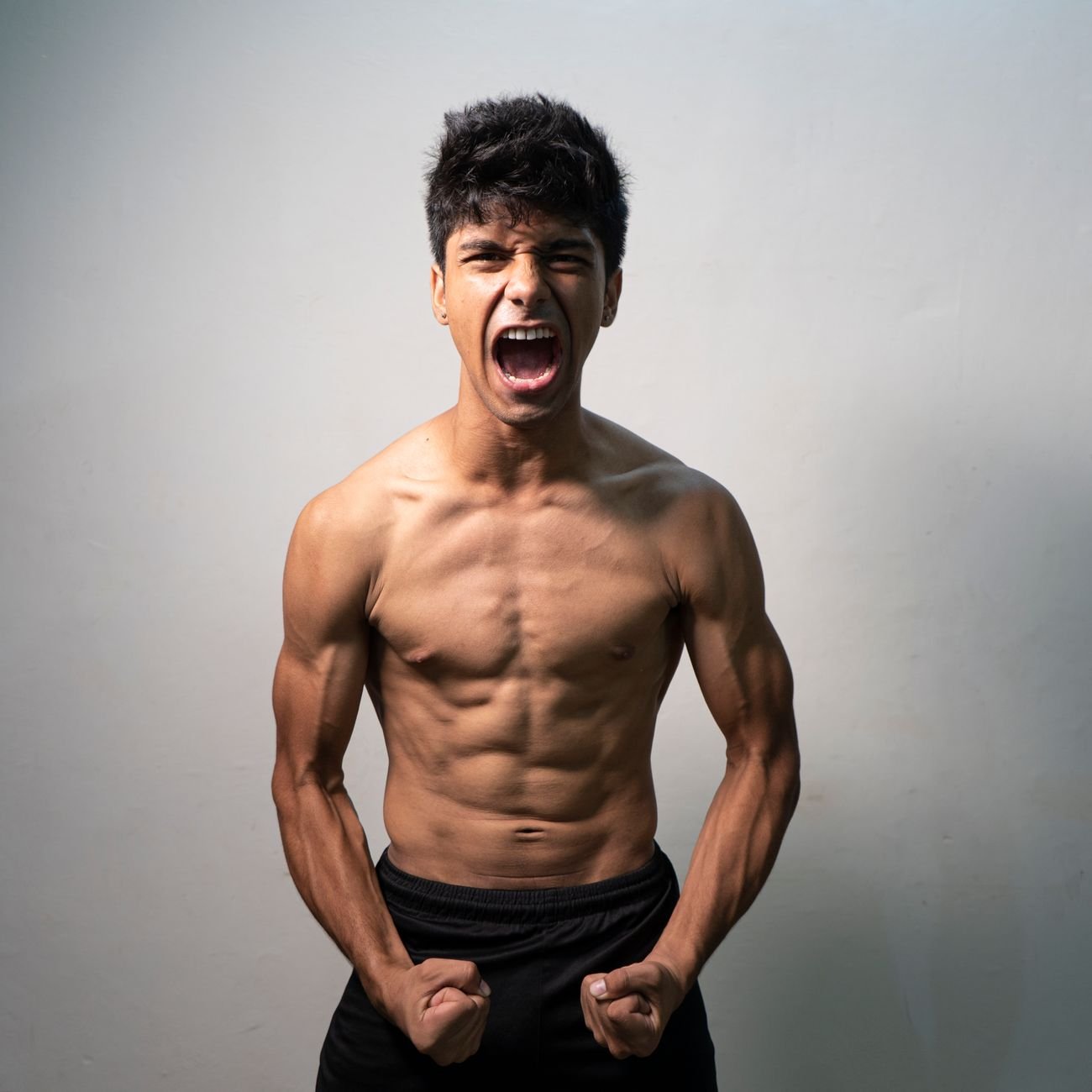 topless man in black shorts