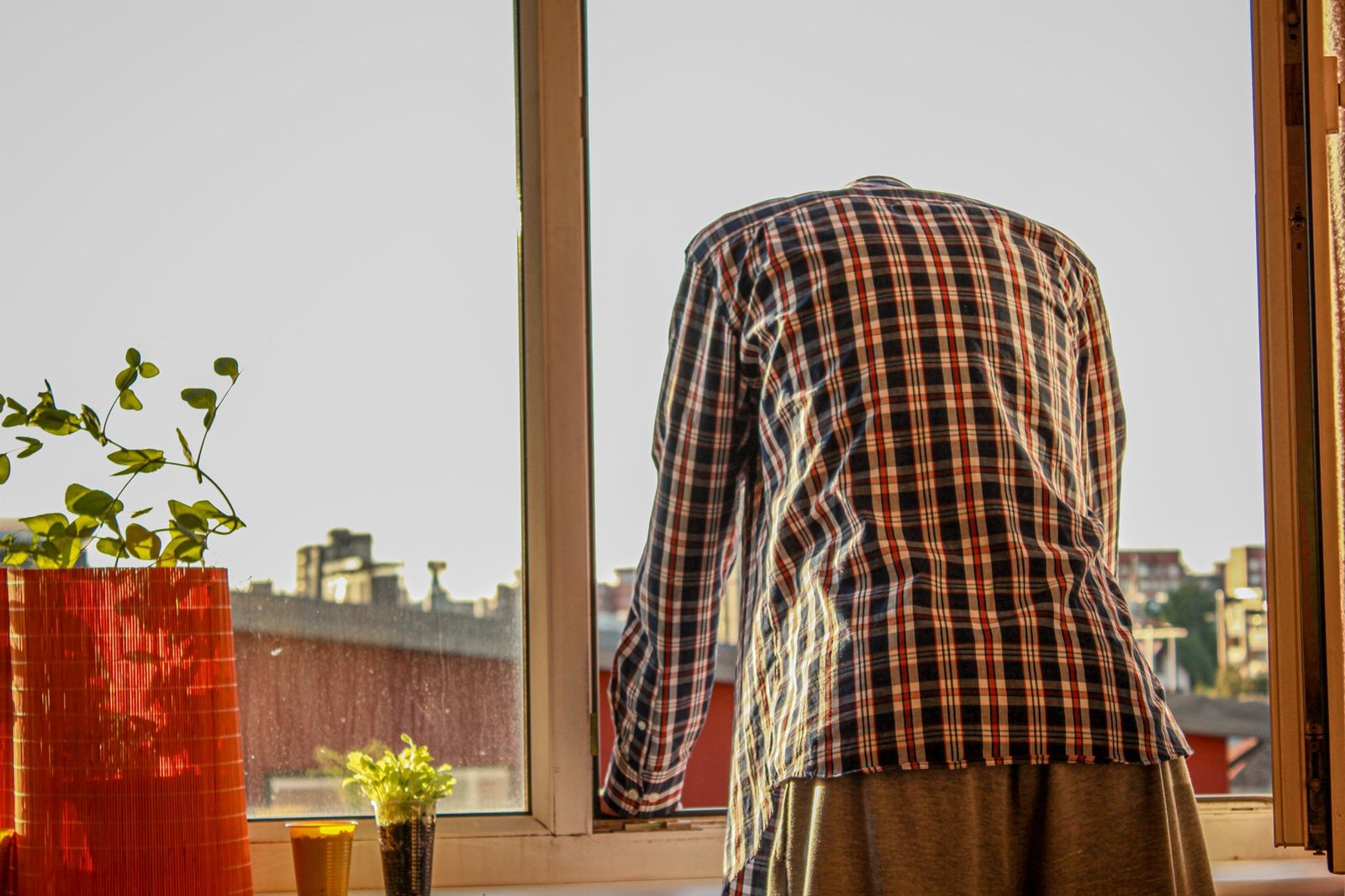 man looking down through window