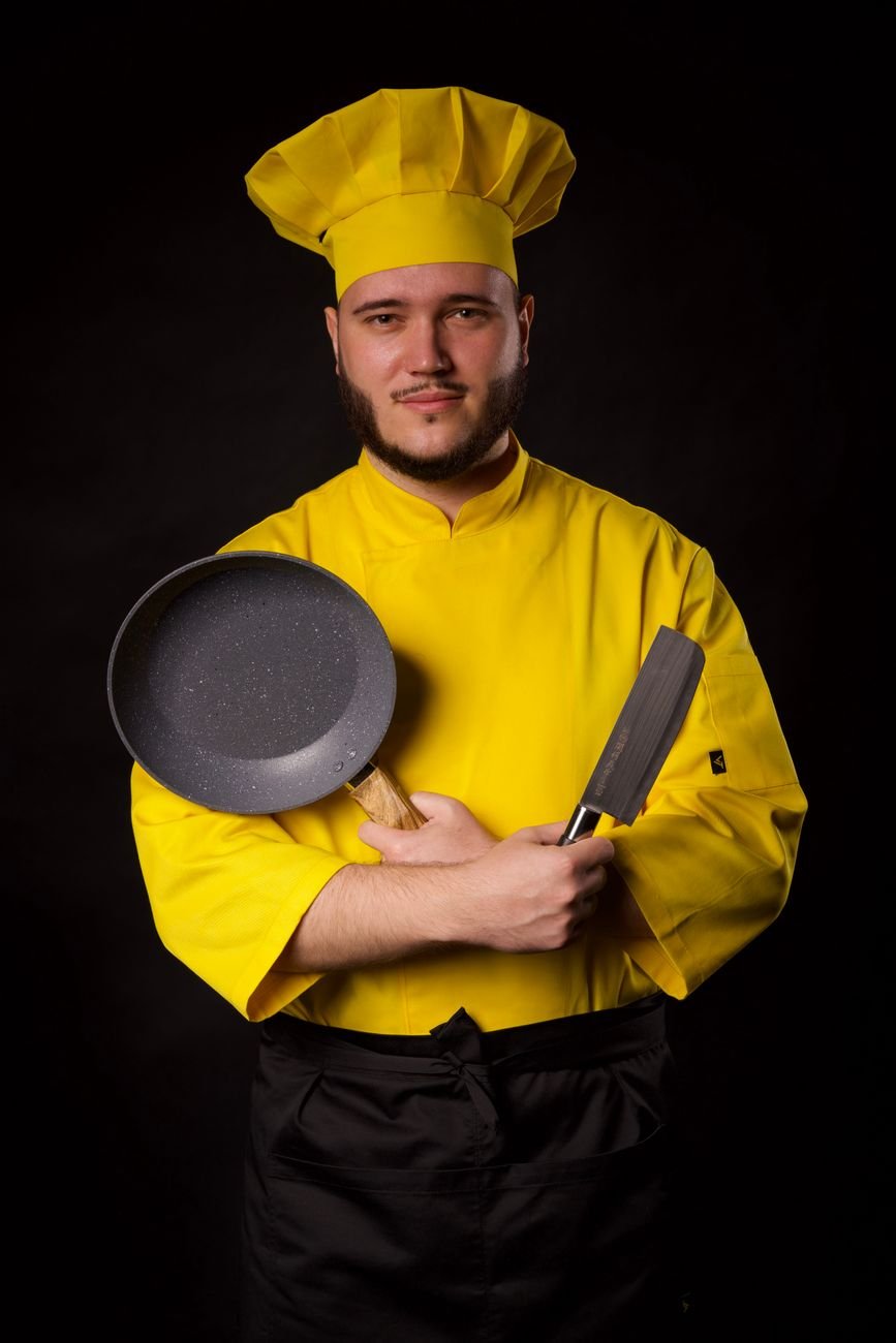 portrait of cook with knife and pan