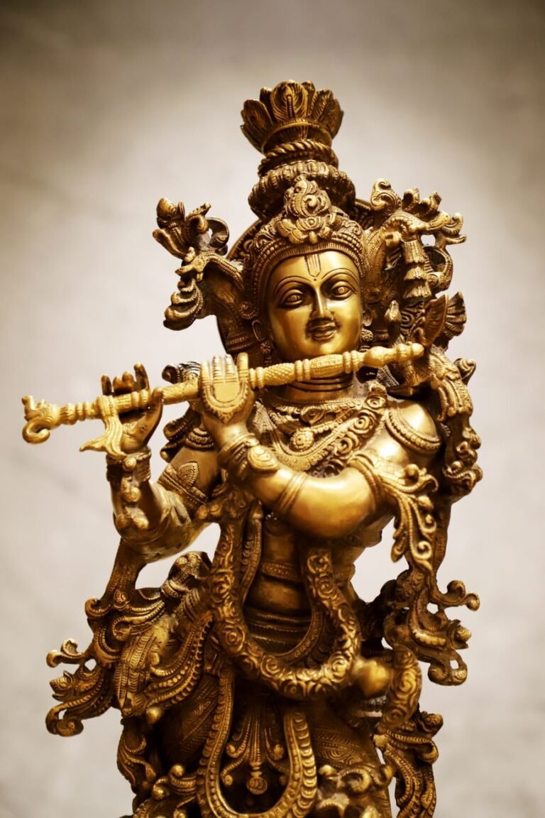 detailed brass statue of hindu deity playing flute