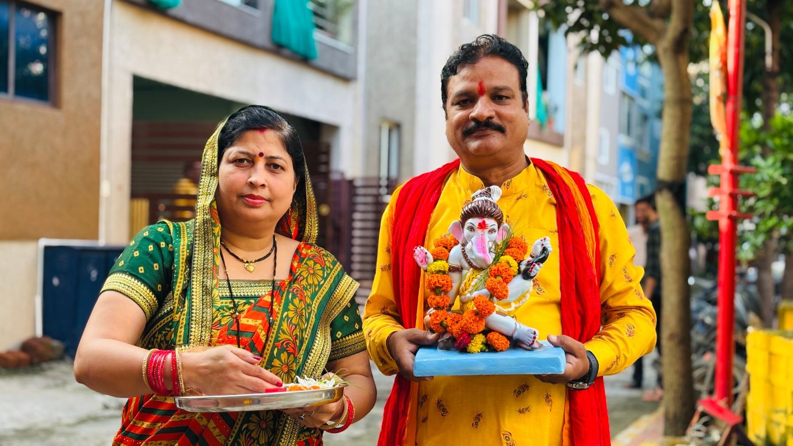 couple celebrating ganesh chaturthi outdoors
