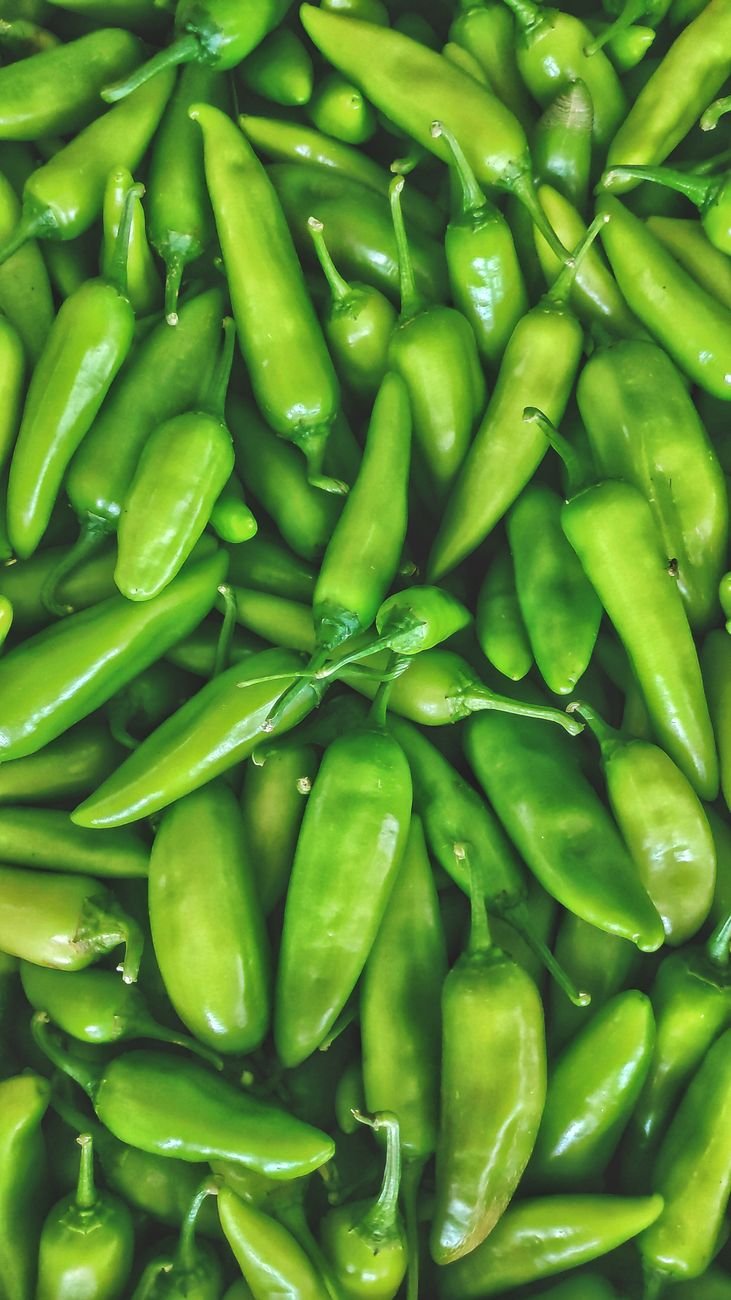 green chili peppers in close up photography