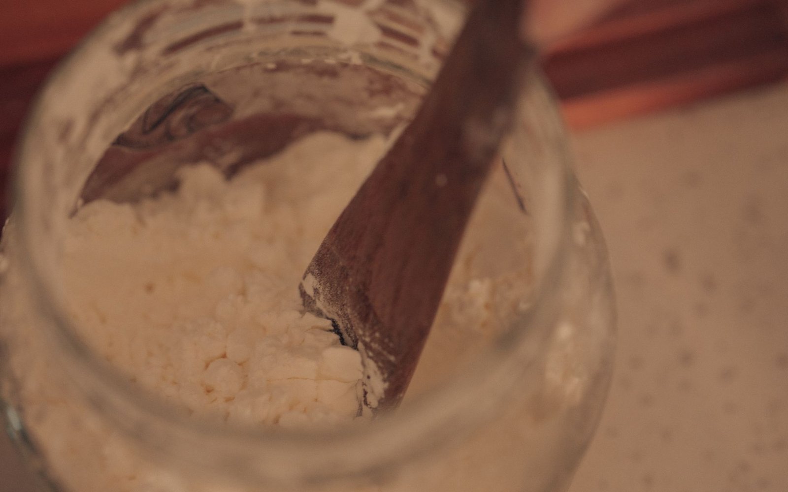 wooden spoon in jar of powdered ingredient