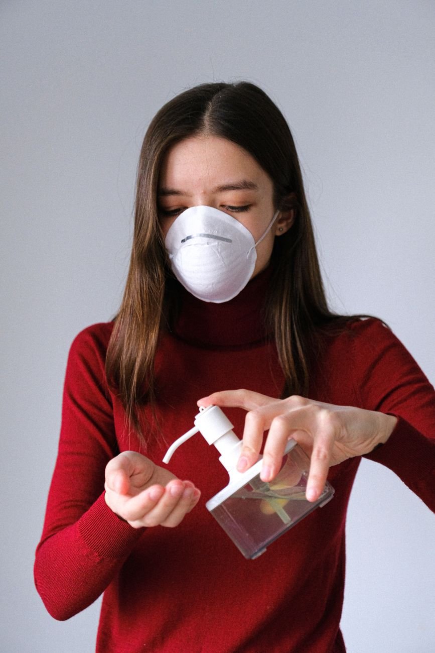 woman applying hand sanitizer