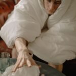 woman in white hijab sitting on chair