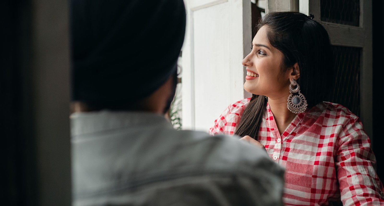 cheerful indian wife spending time with crop husband at home