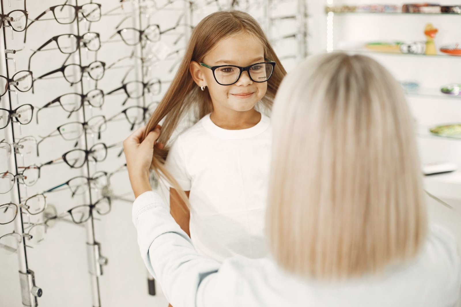 a young girl wearing a black framed eyeglasses