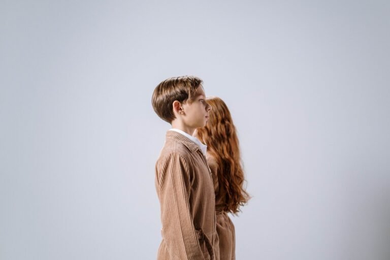 side view of a boy in a brown corduroy jacket
