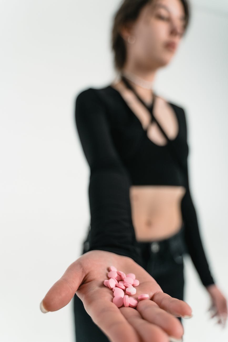 a woman with drugs on the palm of her hand