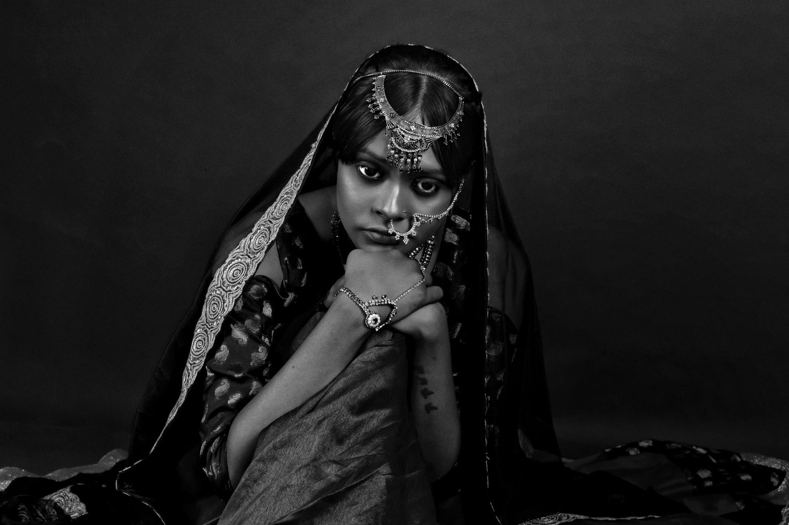 grayscale photo of a woman in traditional wear