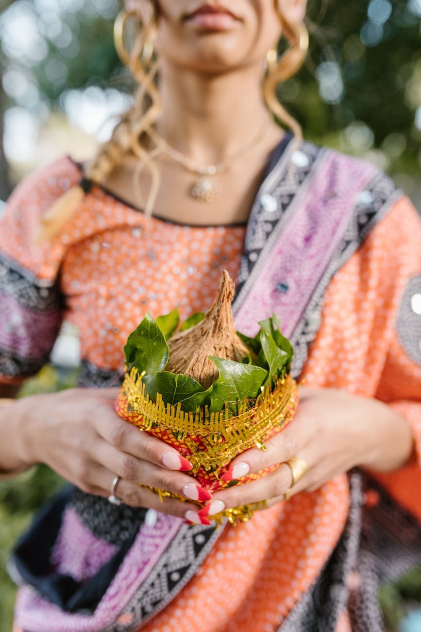 a woman holding a kalasha