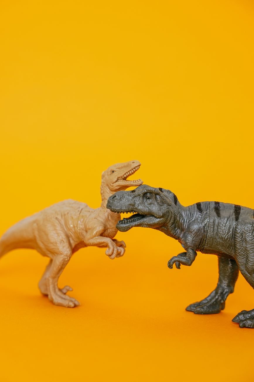 dinosaur toys on a yellow surface