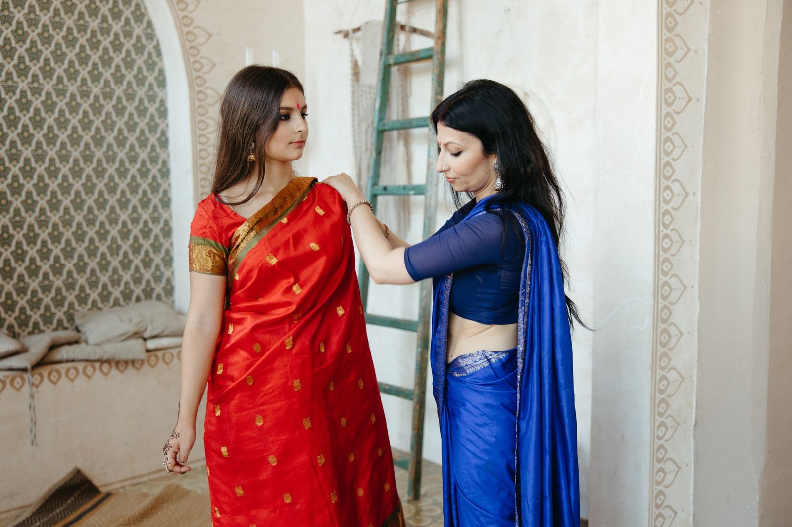 women putting on a red shawl