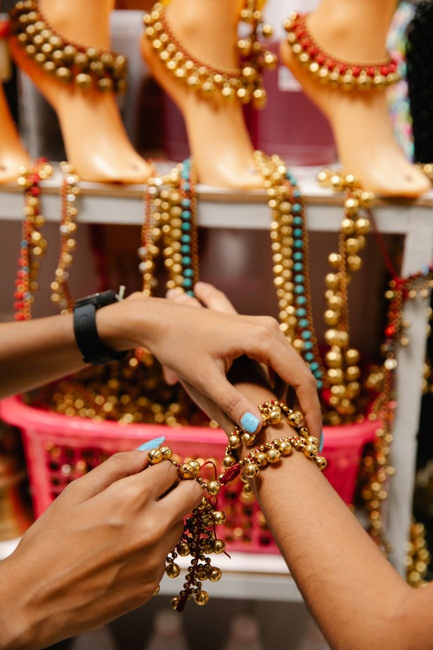 a person wearing gold beaded bracelet