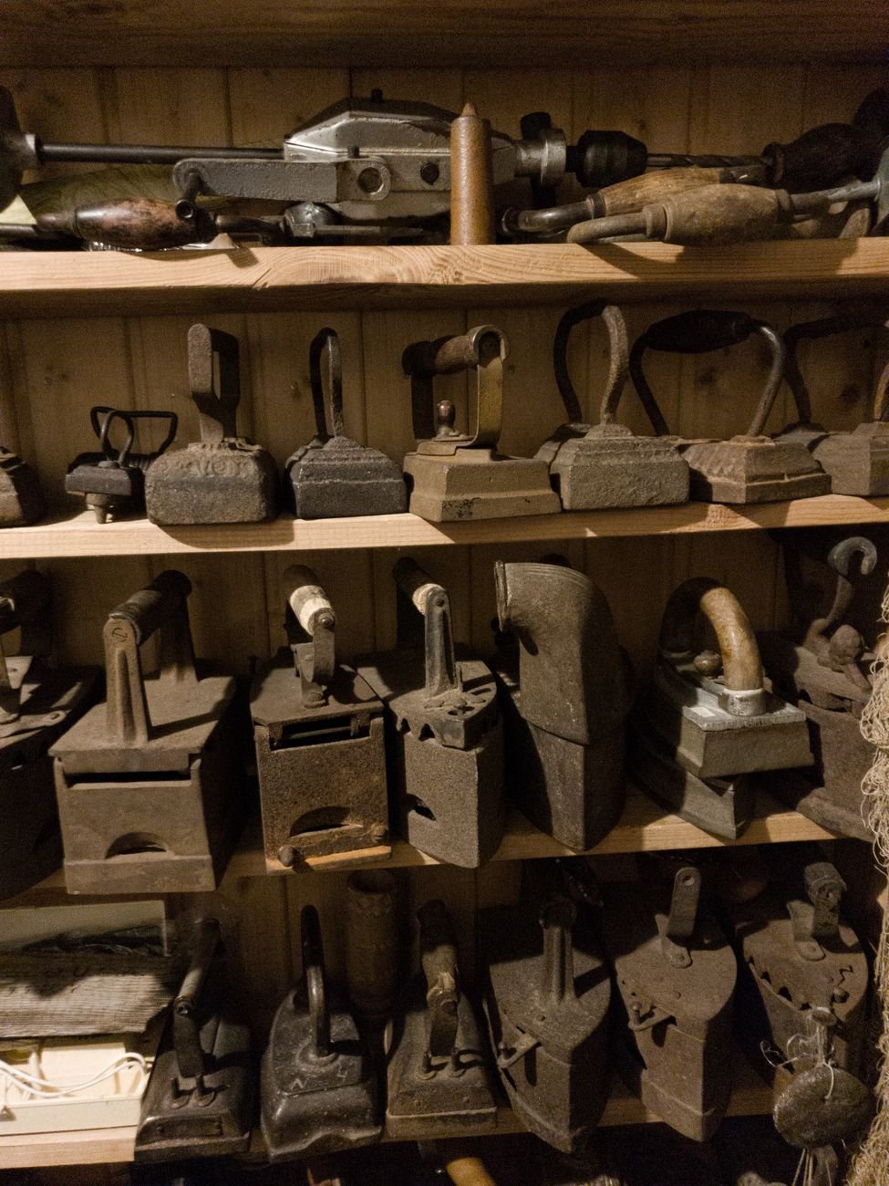 antique clothes iron on a wooden shelf