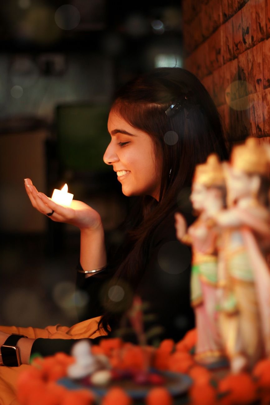 brunette woman holding a candle
