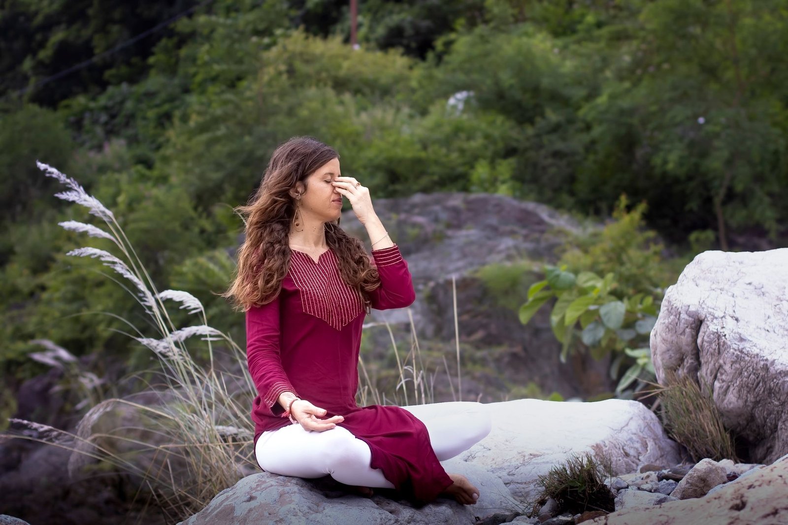woman practicing yoga outdoors in rishikesh