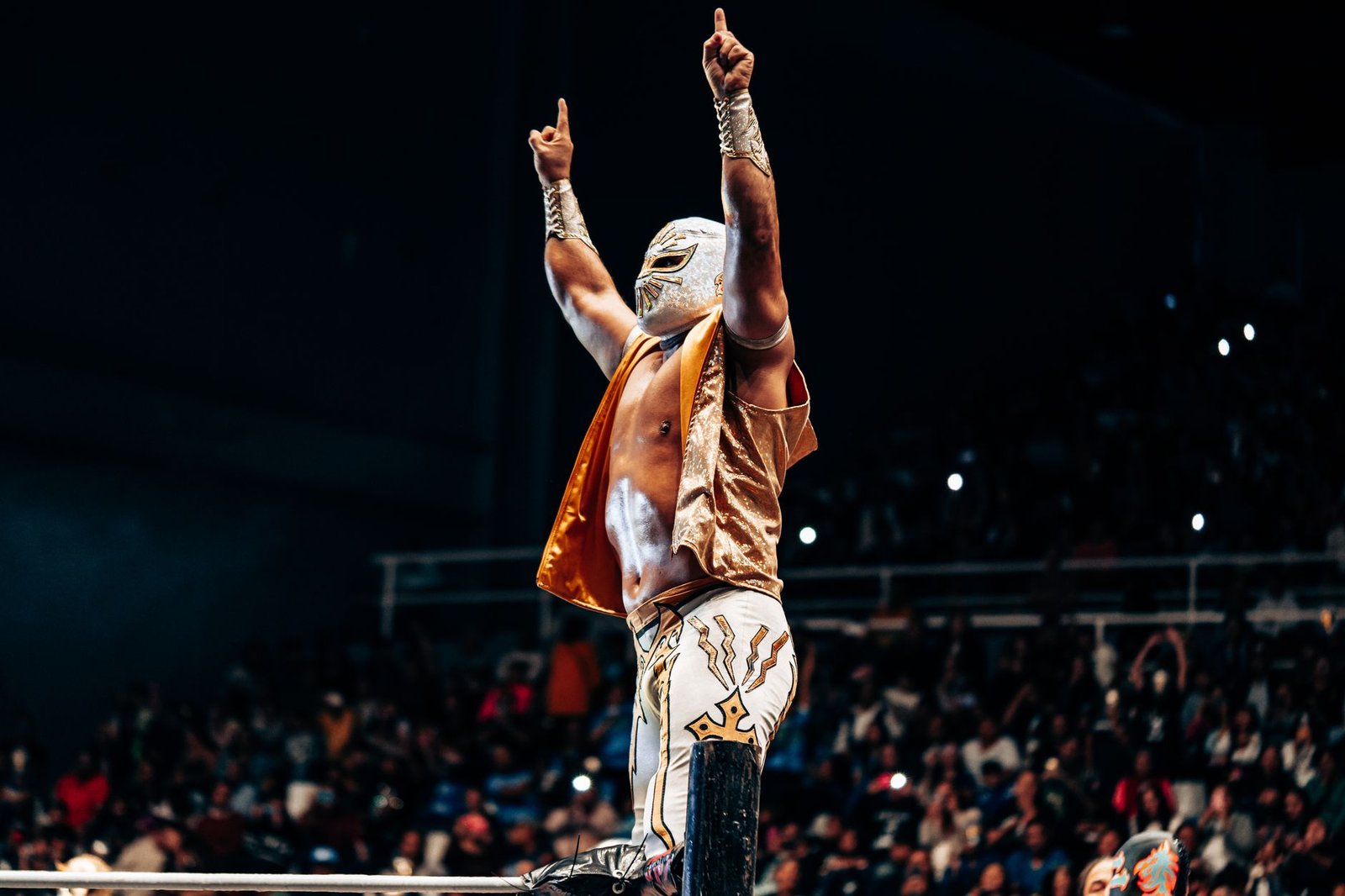 luchador celebrating in mexican wrestling arena