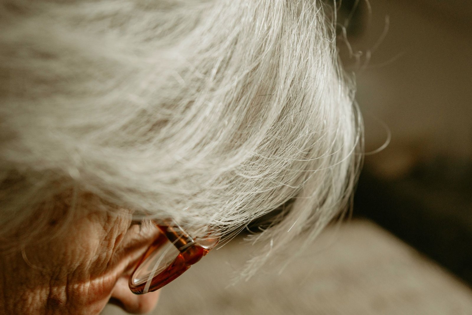 close up of elderly person with glasses and white hair