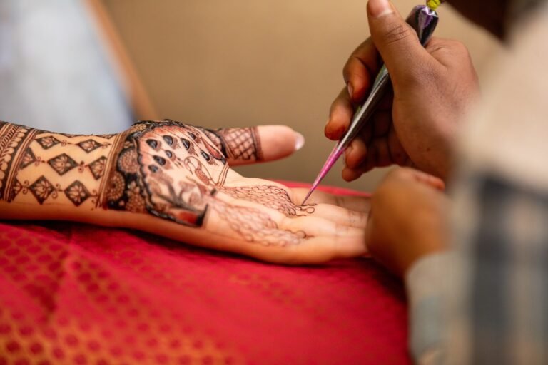 intricate henna art design being applied to hand