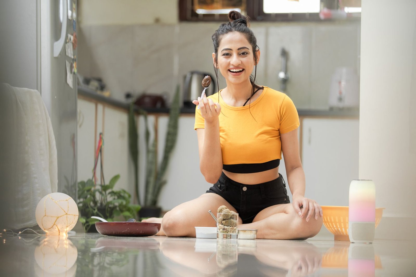 cheerful woman enjoying dessert in modern kitchen