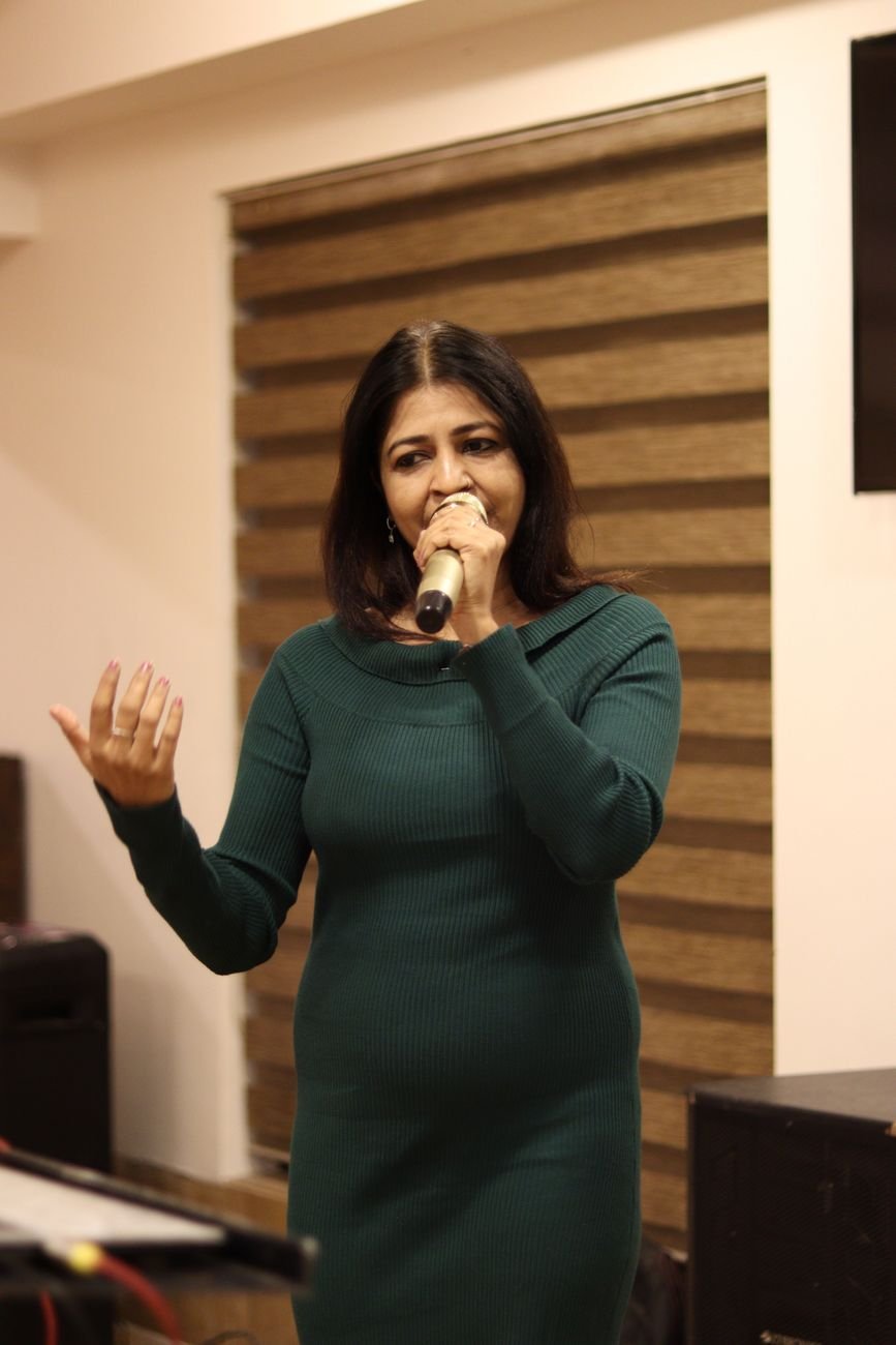 woman singing at indoor event in ahmedabad