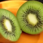 close up of fresh kiwi fruit halves on plate