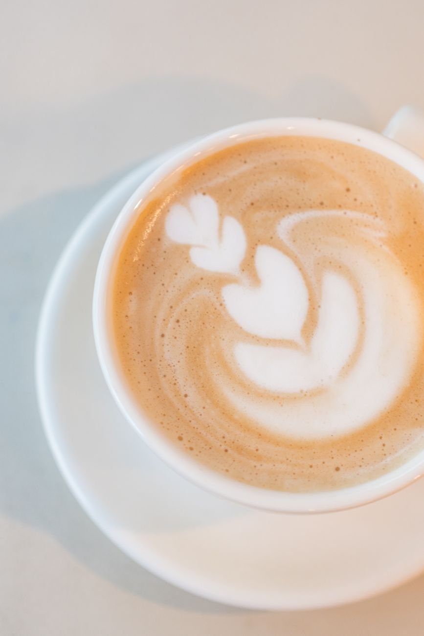 artistic latte art in a white cup