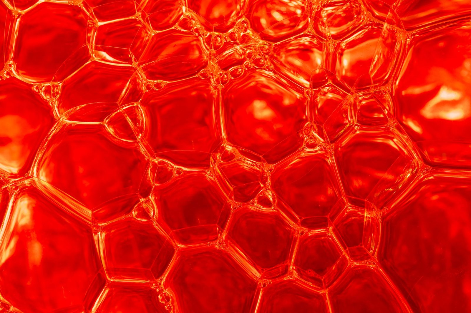 close up of red soap bubbles with abstract patterns