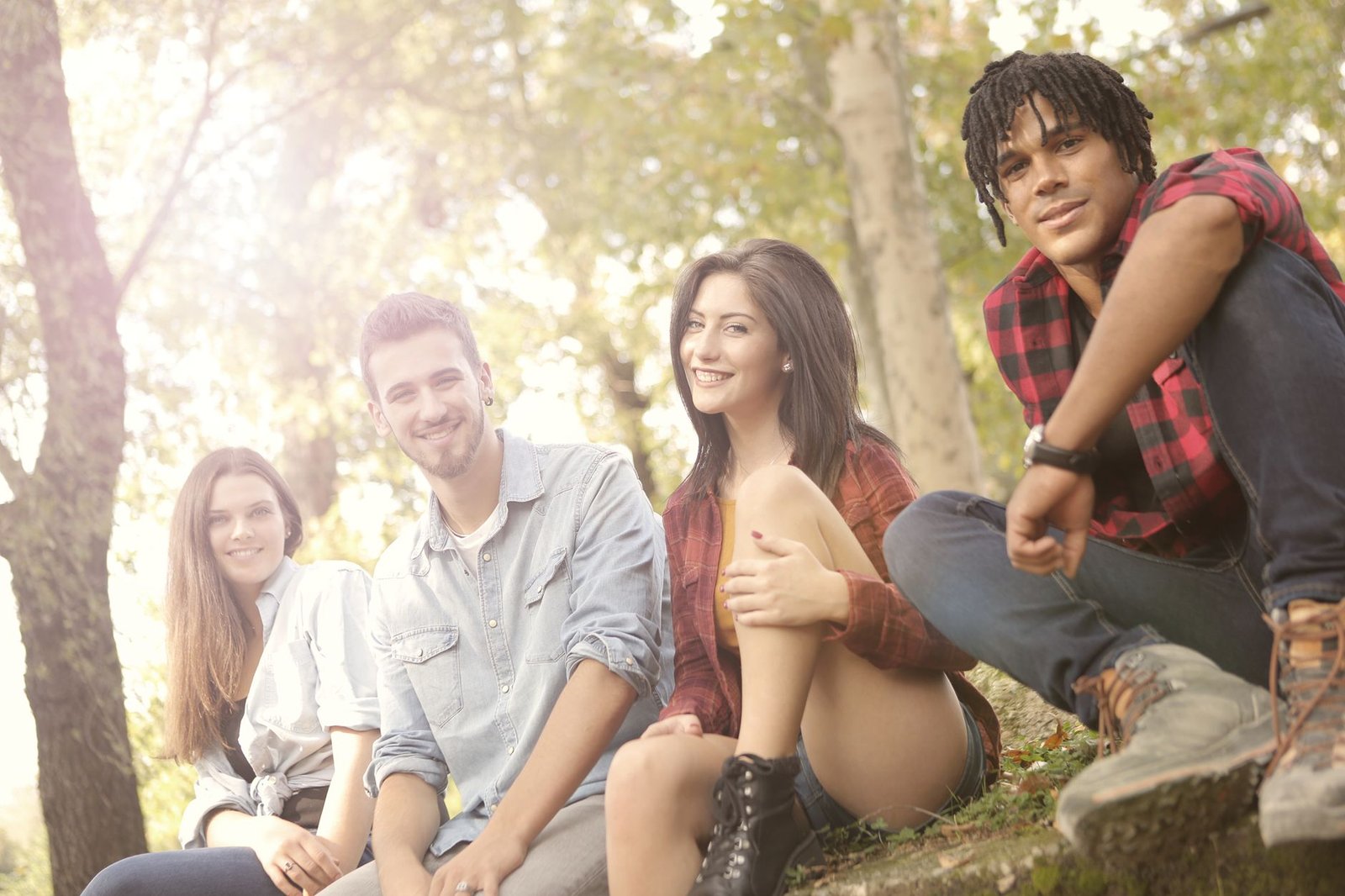photo of people sitting while smiling