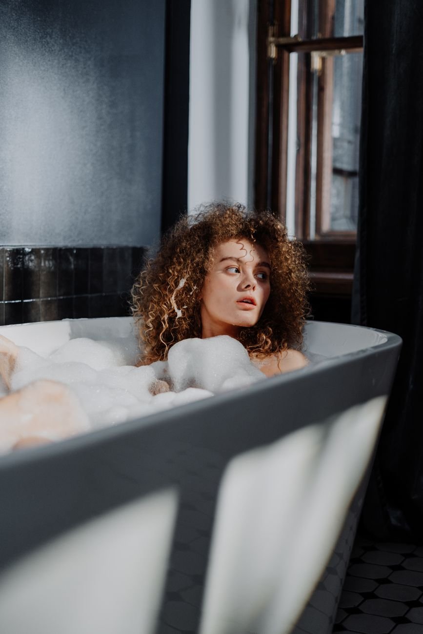 woman in bathtub with bubbles