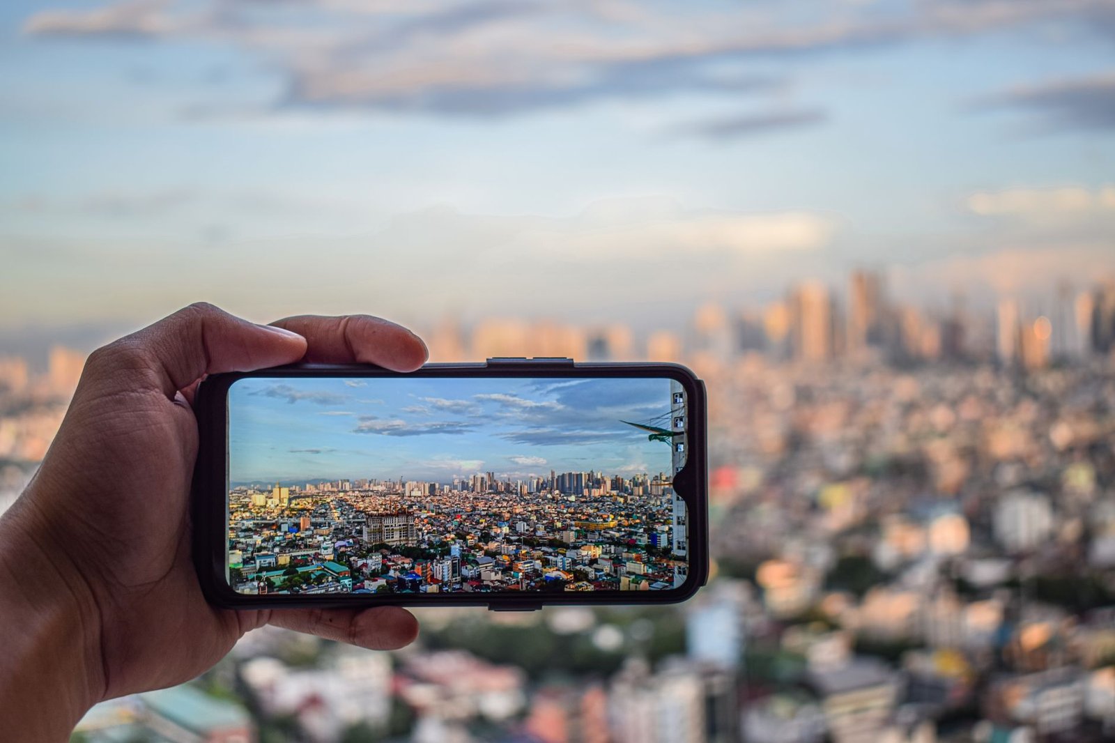 hand taking photo of city