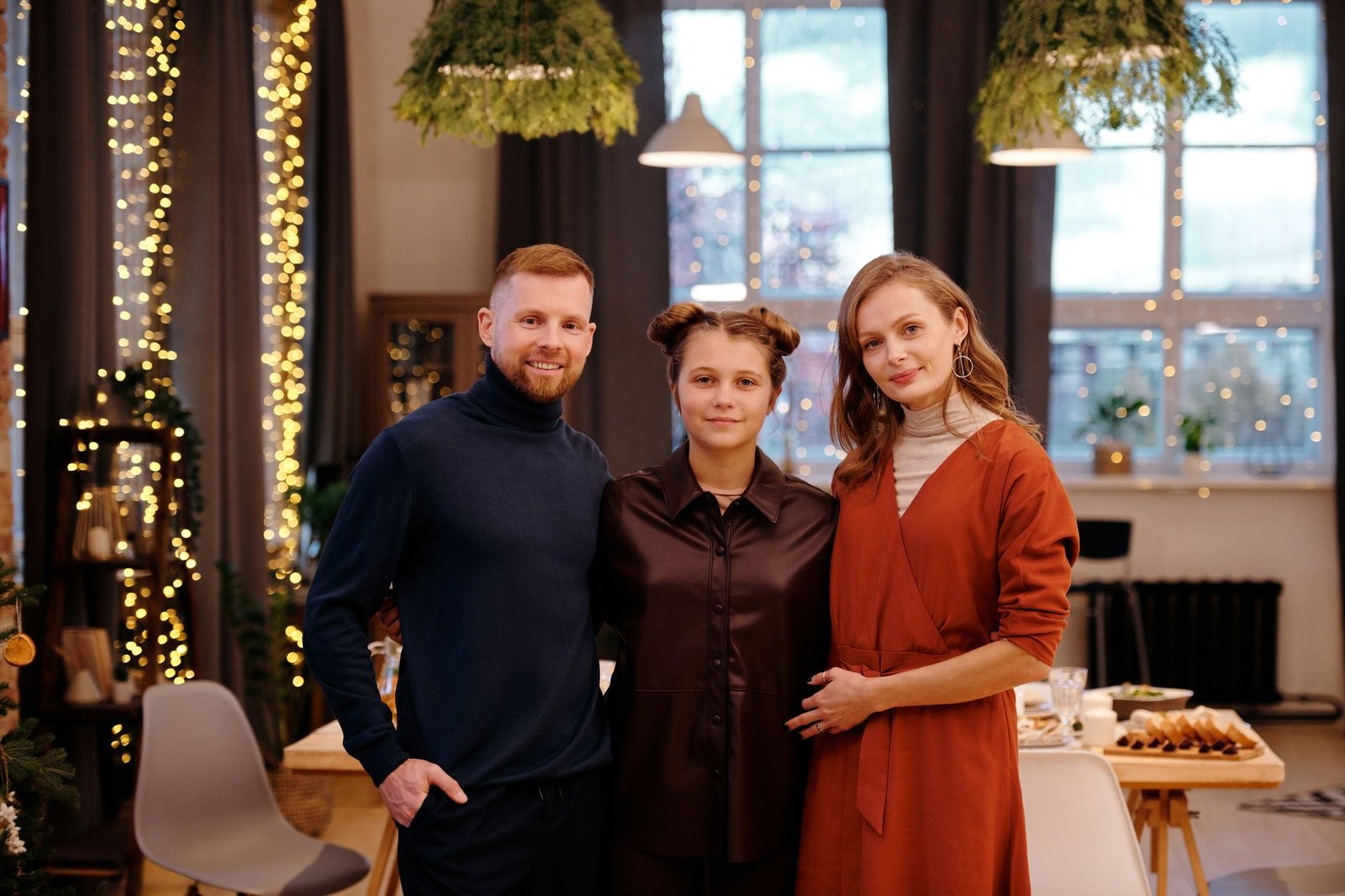 family smiling while looking at the camera