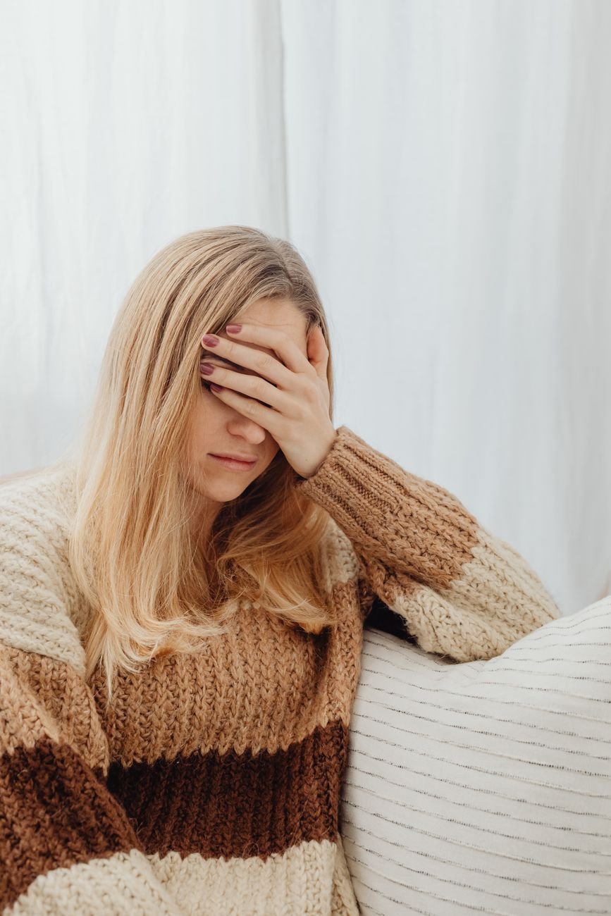 tired woman with hand on forehead