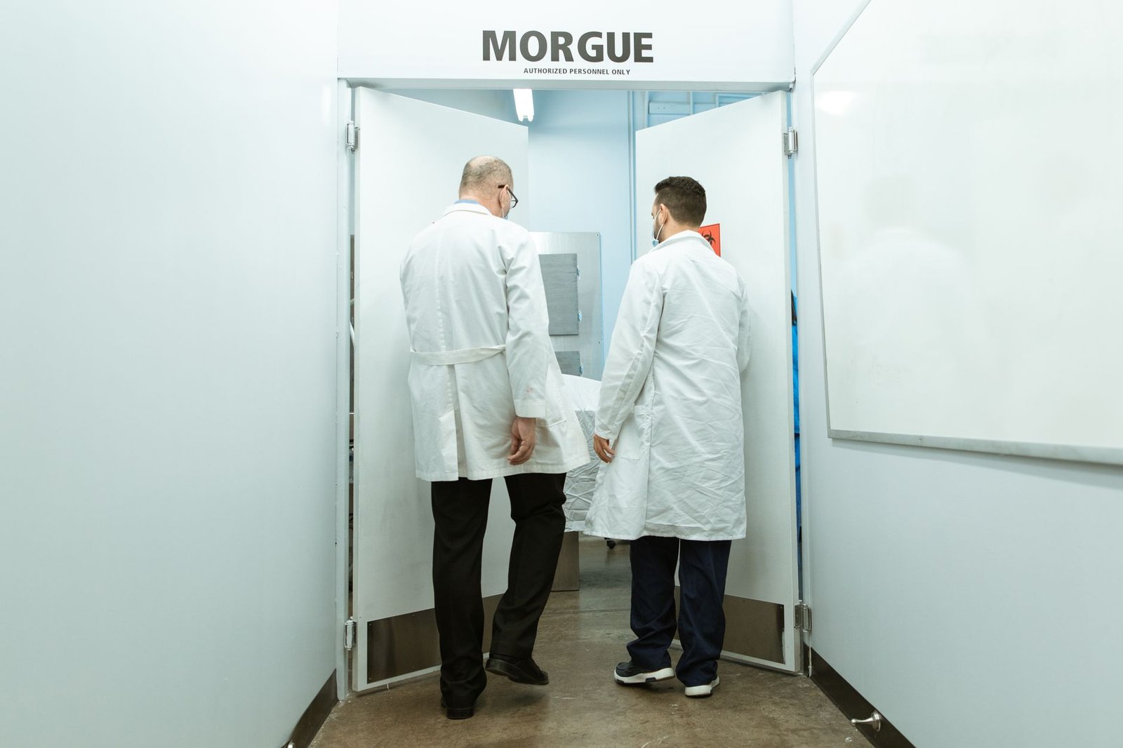 two doctors entering a morgue