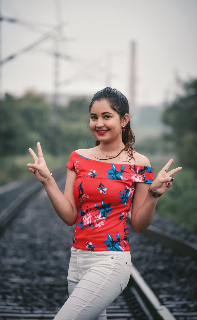 a woman wearing a floral top