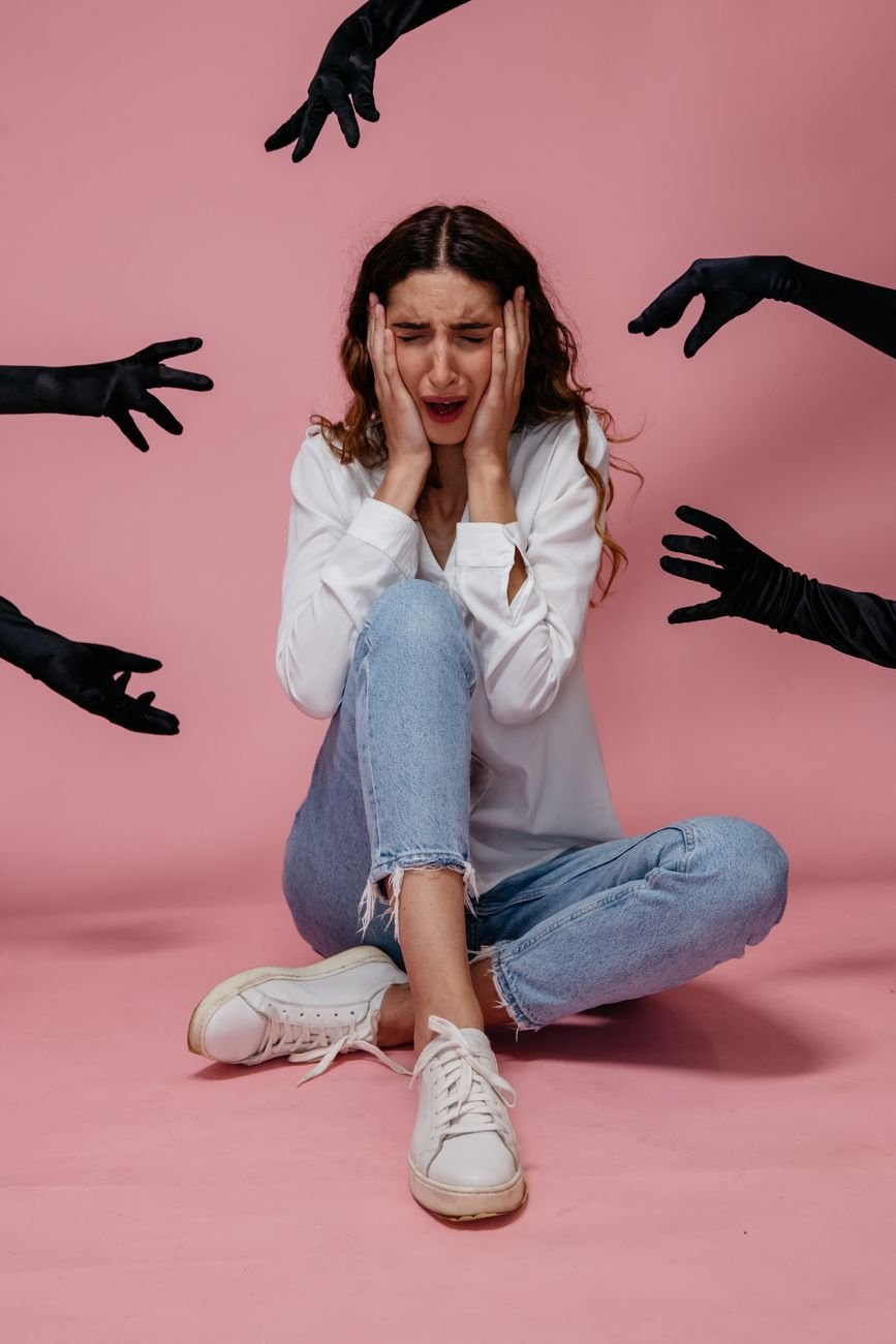 woman in white long sleeve shirt and blue denim jeans feeling scared