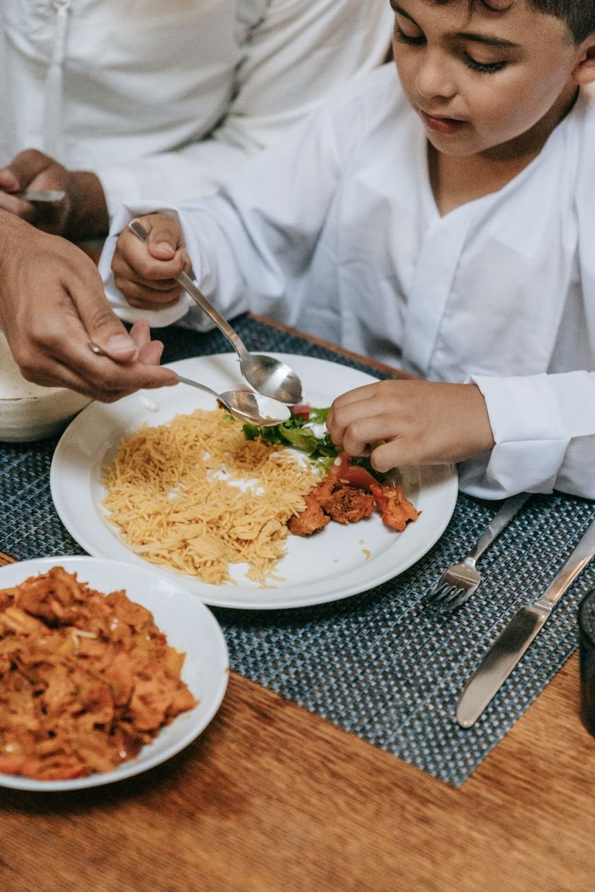 a boy eating on the table