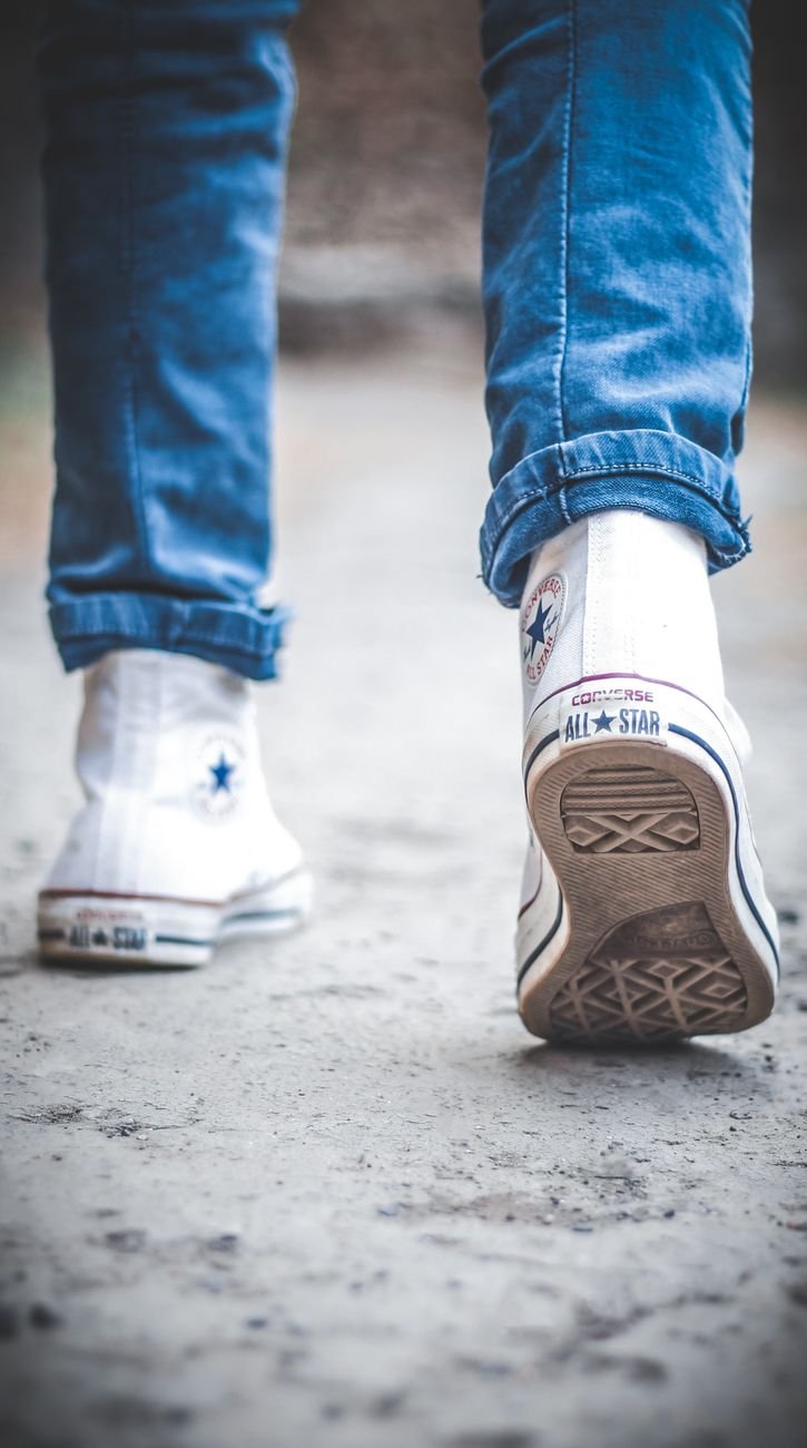 person wearing converse sneakers