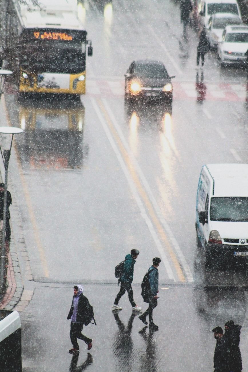 people walking on street while raining