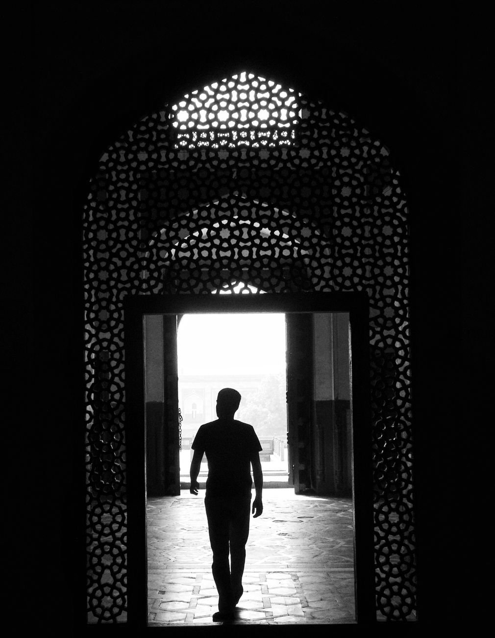 man in door opening in black and white