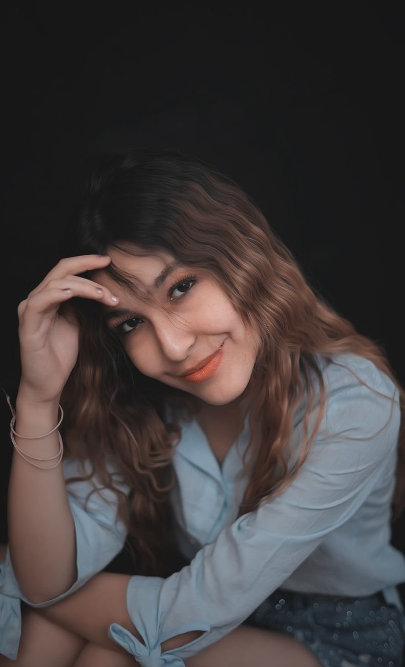 smiling woman in blue shirt