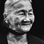 elderly woman smiling in outdoor portrait
