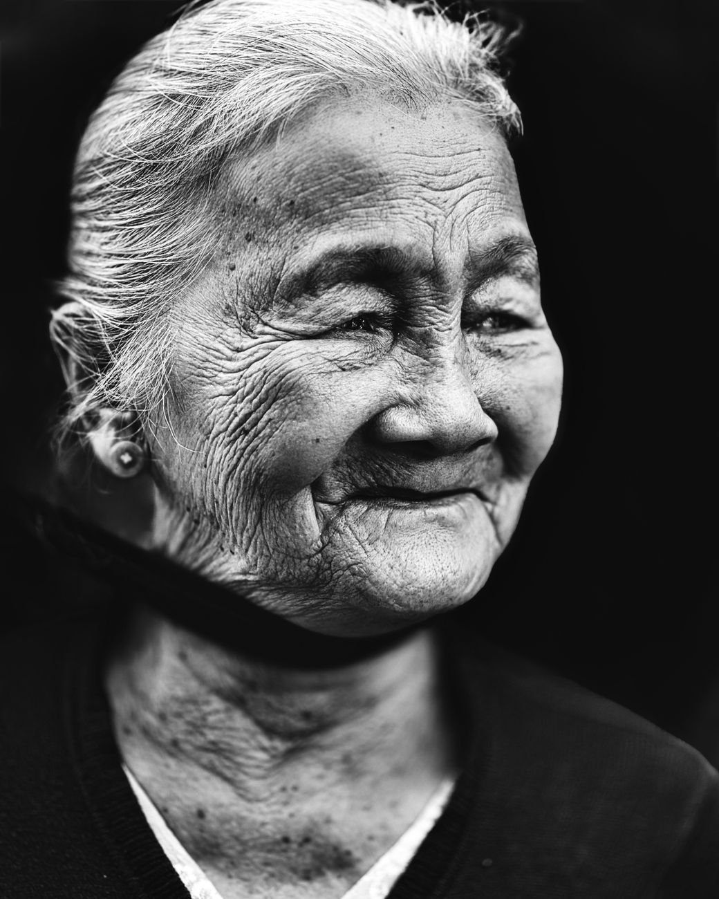 elderly woman smiling in outdoor portrait