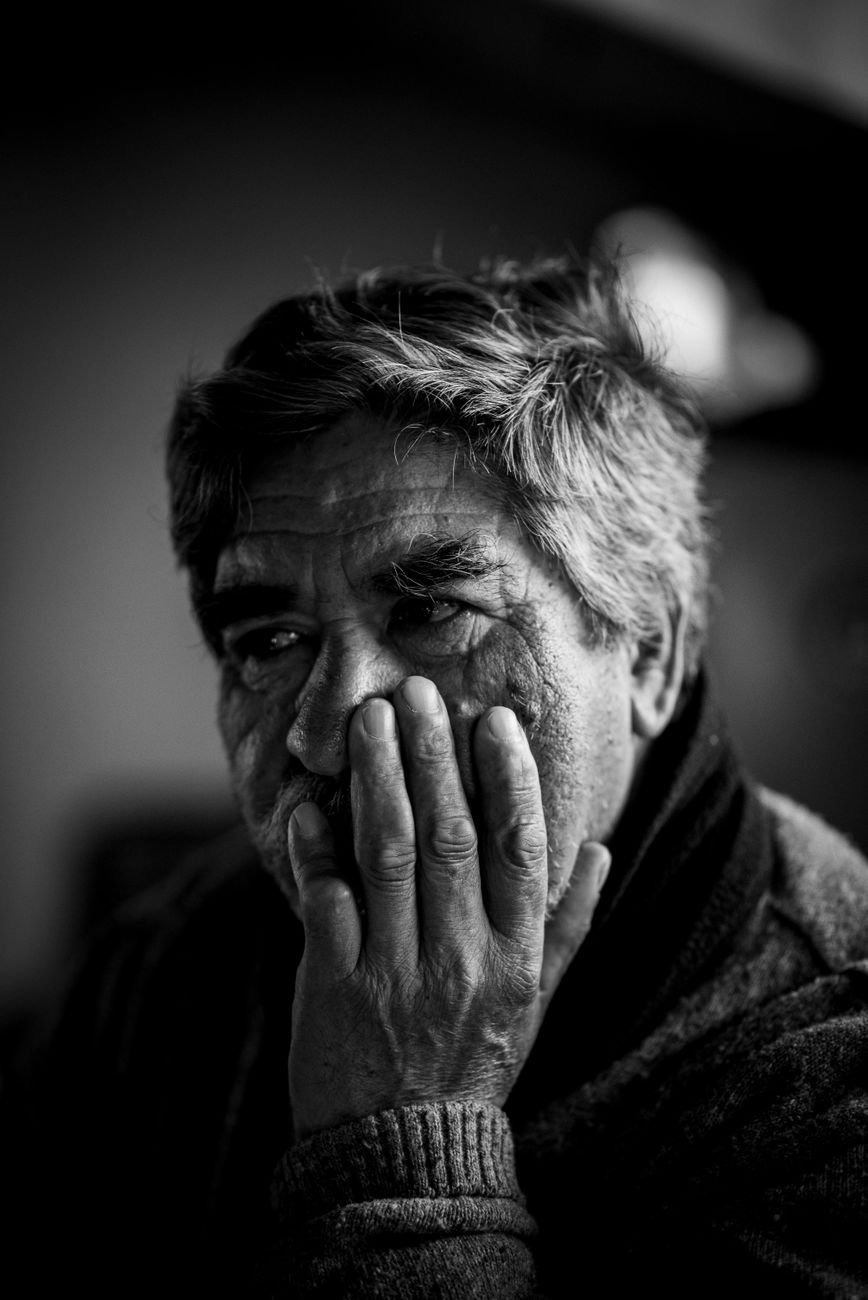 pensive elderly man in black and white portrait