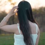 back view of a woman in a white summer dress