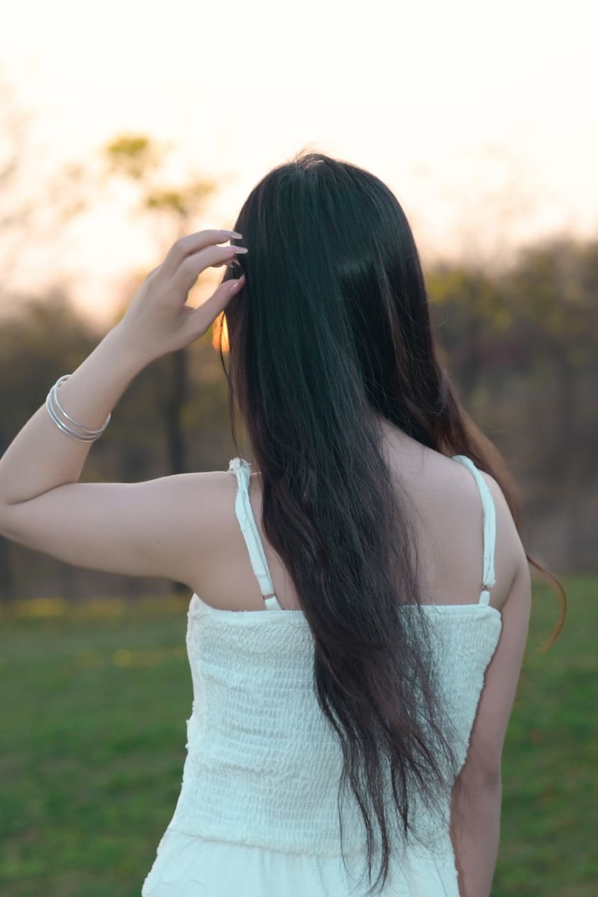back view of a woman in a white summer dress